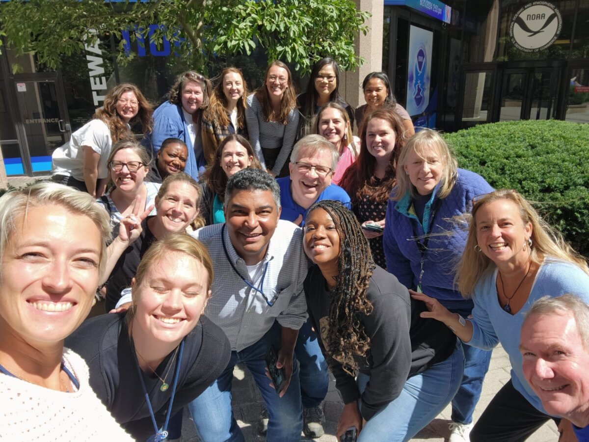 An outdoor group selfie of the GOMO team.